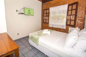 Ένα ή περισσότερα κρεβάτια σε δωμάτιο στο Pousada Casuarina Geribá