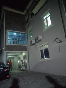 a building with a wall with windows on it at Pulville Boulevard in Lagos