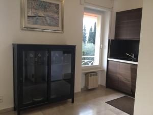 a kitchen with a black cabinet and a window at Casa Claudia in Assenza di Brenzone +14 photos