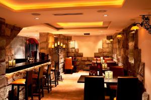 a restaurant with a bar and tables and chairs at Ikala Quito Boutique Hotel in Quito