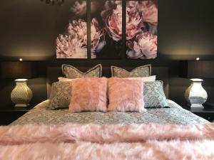 a bedroom with a bed with pink flowers on it at Adelaide Hills Retreats in Balhannah