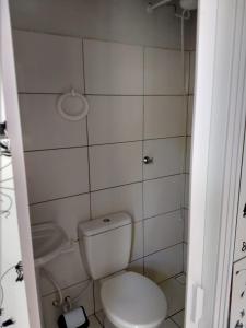 a small bathroom with a toilet and a sink at Sobrado Terezinha in Foz do Iguaçu