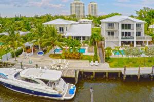 a boat docked at a dock in front of a house at Villa Estelle in Miami