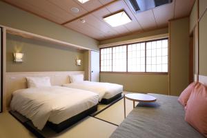 Postel nebo postele na pokoji v ubytování Gion Ryokan Karaku
