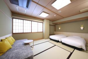 Postel nebo postele na pokoji v ubytování Gion Ryokan Karaku
