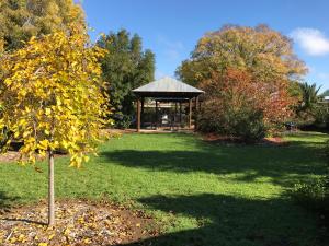 a gazebo in the middle of a park at River Country Inn in Moama