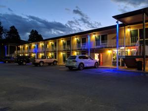 a car parked in a parking lot in front of a motel at Budget Inn Top of Ellijay in Ellijay