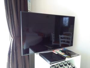a large flat screen tv sitting on top of a table at Colonial Lodge Motel in Taupo