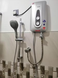 a bathroom with a blow dryer and a microphone at Flip Flop Inn Mirissa in Mirissa