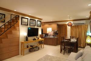 a living room with a kitchen and a dining room at Stay Amare Bayswater Mactan in Mactan