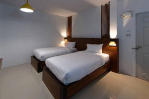 Ein Bett oder Betten in einem Zimmer der Unterkunft Kanlaya Place