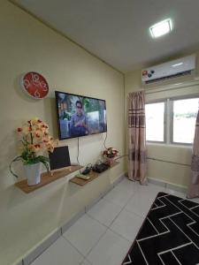 a living room with a flat screen tv on the wall at villa tempoyak homestay in Pantai Cenang +47 photos
