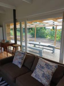 a living room with a couch and a table at Rosendale Stables in New Norfolk