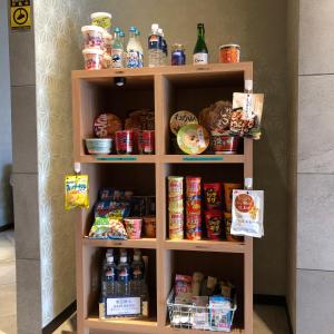 a book shelf with food and drinks on it at Cabin House Yado Fujinomiya in Fujinomiya