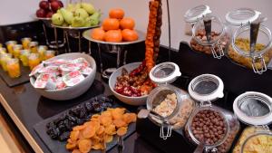 a buffet with different types of food on a table at Ramada Hotel & Suites by Wyndham Yerevan in Yerevan