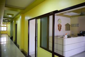 um corredor de escritório com paredes amarelas e verdes em Jupiter Lodge em Siliguri