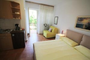 a living room with a couch and a kitchen at Mira Apartments in Novigrad Istria