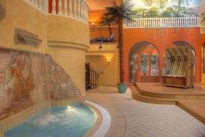 a swimming pool in a building with a fountain at SEETELHOTEL Ostseeresidenz Heringsdorf in Heringsdorf