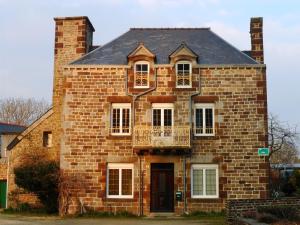 an old brick house with two windows and a door at Gite Mont Saint Michel "AUCOEURDELABAIE" in Sains