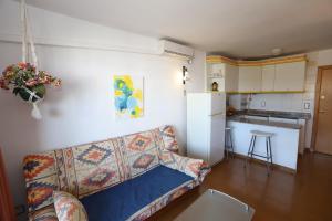 a living room with a couch and a kitchen at COSTA DAURADA APARTAMENTS - Marathon II in Salou