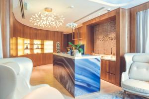 a lobby with a blue counter and two chairs at Hard Rock Hotel Desaru Coast in Desaru