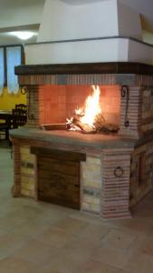 a brick oven with a fire inside of it at Agriturismo Isola Verde in SantʼUrbano