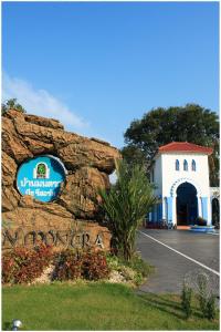 a sign on a rock in front of a building at Baanmontra Beach Resort - Bankrut in Ban Krut