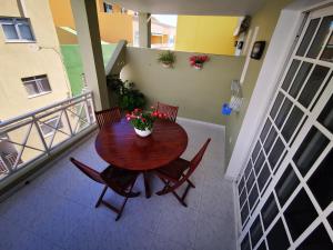 a wooden table and chairs on a balcony at Apartamento Candil in Puerto Naos