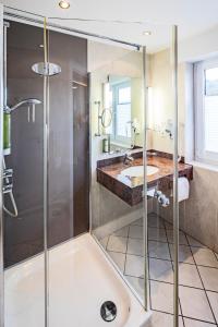 a bathroom with a shower and a sink at Hotel Menge "An der Schlacht" in Arnsberg