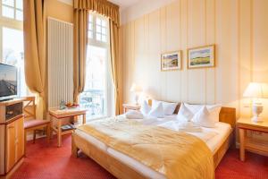 Postel nebo postele na pokoji v ubytování Strandhotel Möwe