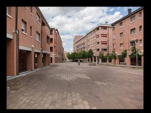 an empty street in a city with tall buildings at Room Touch And Go in Bologna