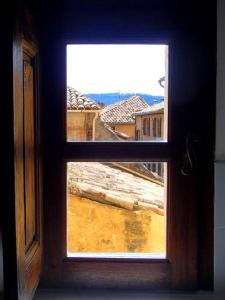an open window with a view of a city at Le 1835, Studio Ambre-Jaune in Moustiers-Sainte-Marie