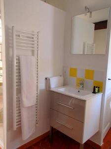 a white bathroom with a sink and a mirror at Le 1835, Studio Ambre-Jaune in Moustiers-Sainte-Marie +14 photos