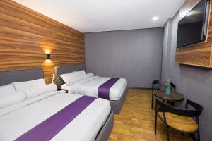 Postel nebo postele na pokoji v ubytování Axiaa Hotel