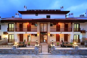 a large white building with a porch and balcony at Akyaka Deger Apart in Akyaka