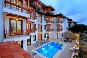a house with a swimming pool in front of it at Akyaka Deger Apart in Akyaka