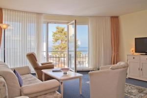 a living room with a couch and chairs and a television at SEETELHOTEL Ostseeresidenz Bansin in Bansin