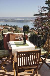 a bottle of wine sitting on a table on a patio at BBP apartment in Portorož