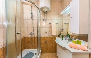 a bathroom with a shower and a sink at Apartment Leut with spacious terrace and sea view in Slatine +24 photos