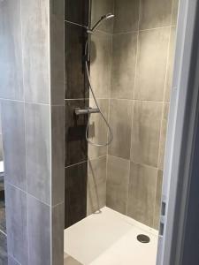 a shower with a glass door in a bathroom at Magnifique T4 avec terrasse à Saint-Nectaire - 8 pers in Saint-Nectaire
