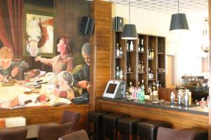 a bar in a restaurant with a painting on the wall at Ducata Hotel - Xirolivado in Xirolívadon