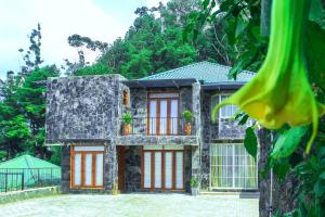 a house with red and white doors at HummingBird Hill Cottage in Nuwara Eliya