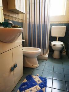 a bathroom with a toilet and a sink at Tenente Amendola 2 in Lipari