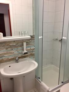 a bathroom with a sink and a shower at Hotel Gloria Budapest City Center in Budapest