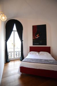 une chambre avec un grand lit et une fenêtre dans l'établissement Suite Calderini, à Pérouse
