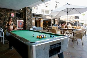 a woman standing in front of a pool table at Princesa Ico in Puerto del Carmen