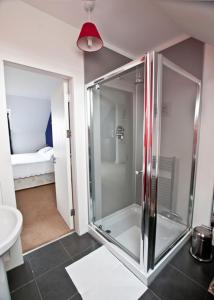 a glass shower in a bathroom with a sink at Beinn Edra House B&B in Staffin