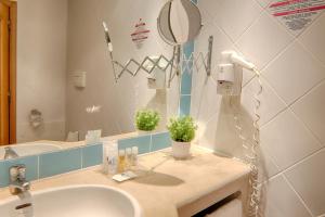 a bathroom with a sink and a mirror at Luna Miramar Club in Albufeira +42 photos