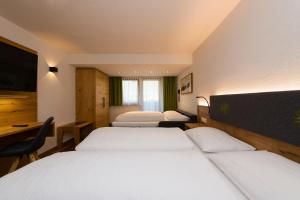 Ein Bett oder Betten in einem Zimmer der Unterkunft Hotel Bergkranz