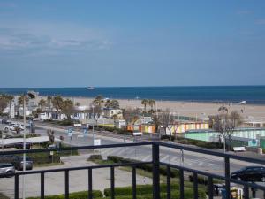 a view of a beach and the ocean from a balcony at Hotel Cobalto in Rimini